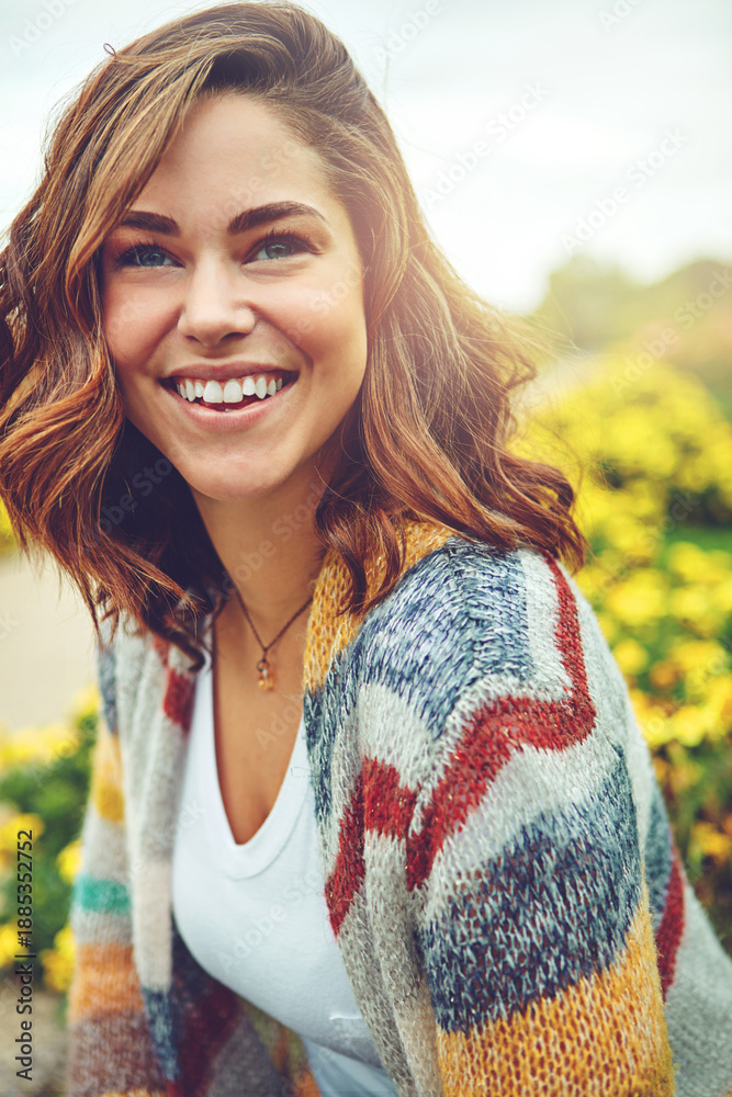 Obraz premium Thinking, woman and happy outdoor for travel, spring adventure and holiday reflection. Smile, female person and vision in nature with floral daisies, sightseeing and vacation getaway in countryside