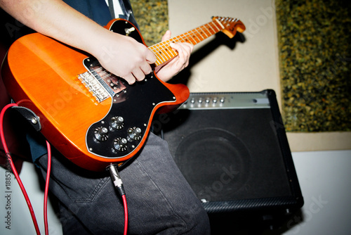 Photography Musician playing electric guitar during rock music rehearsal