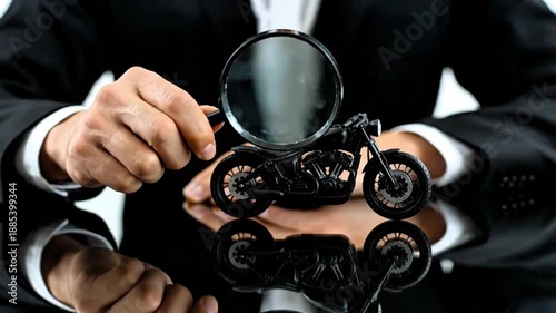 Video, tangible fixed assets background, hands examining 3D motorcycle assets with magnifying glass, investment, lifestyle, vehicles, 