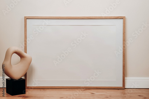 Horizontal Frame Presentation Featuring Abstract Sculpture On Low Pedestal Against Warm Wooden Flooring