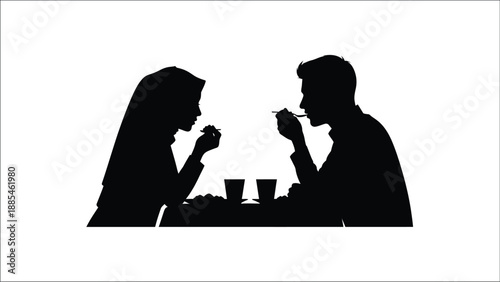 Silhouetted couple enjoying a meal together at a dimly lit table