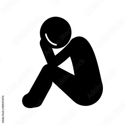 Silhouette of a person sitting with head in hand expressing sadness
