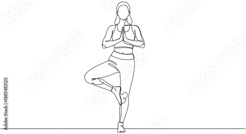 Woman Practicing Yoga in Tree Pose.