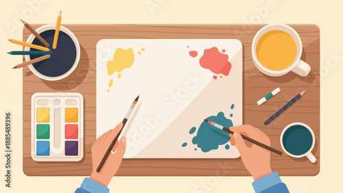 Art creation with paint, brushes, pencils, and coffee on wooden desk
