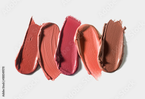Set of colorful lipstick or cream makeup swatches on light background. Beauty product sample swatch concept for cosmetic advertising and design.