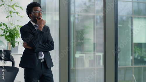 Tableau sur toile Thinking problem solution African American business man looking window in office