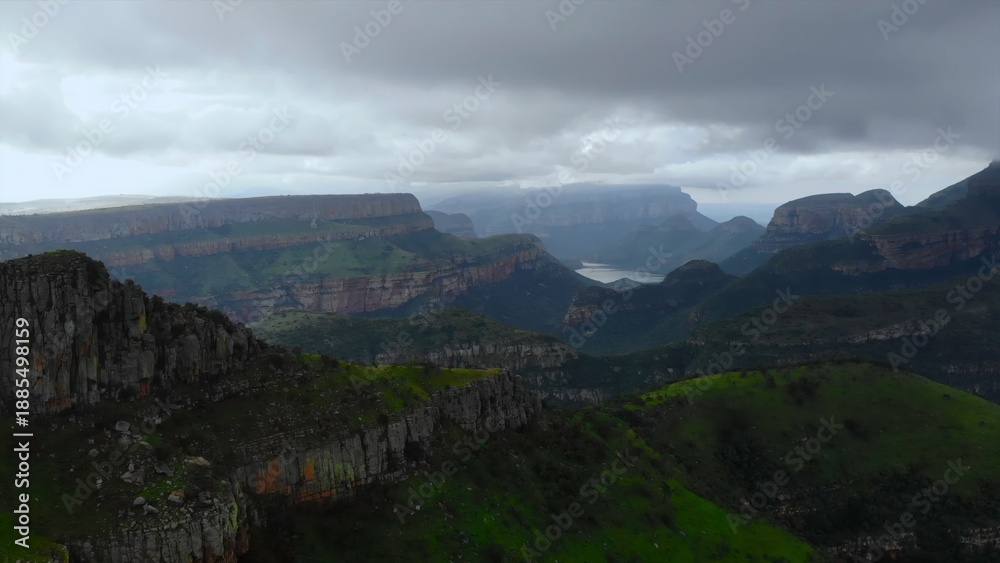 Fototapeta premium layered terraces and ridges, misty conditions conceal stratified ridges and fissured mountain terrain