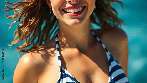 Relaxed vacationer in sailor-stripe swimwear, smiling against a blurred blue ocean backdrop.
