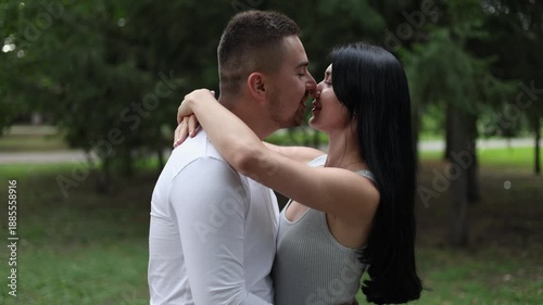 A young couple in love hugs each other with tenderness and love. A happy couple in love kisses. Valentine's Day concept.