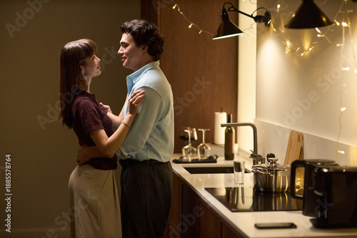 Photos Young Caucasian woman and young Caucasian man standing close together in modern