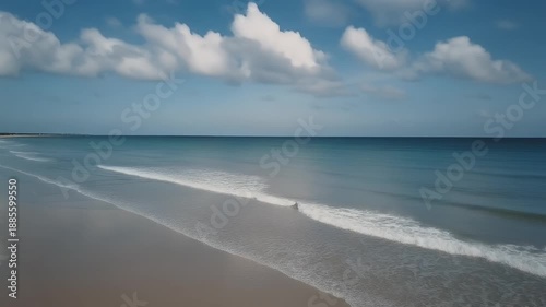 Beautiful beach scene under a blue sky with fluffy clouds