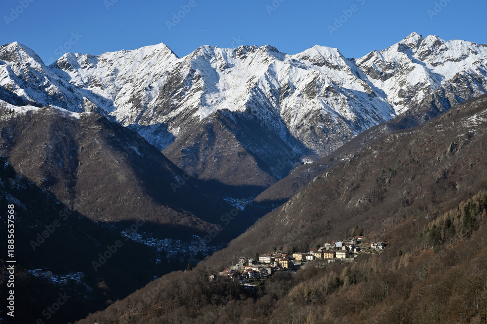 Fototapeta premium Snow-capped mountain peaks on a sunny clear winter day in Piedmont