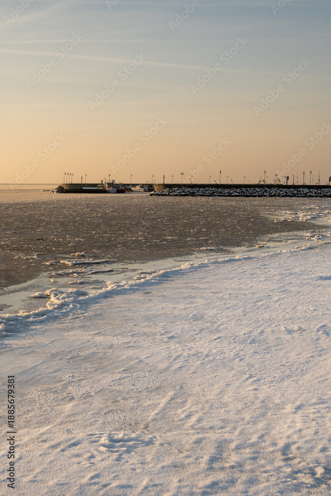 Fototapeta premium Winter coastline of Hel Peninsula with frozen Baltic Sea. Kuznica village in Poland, Europe