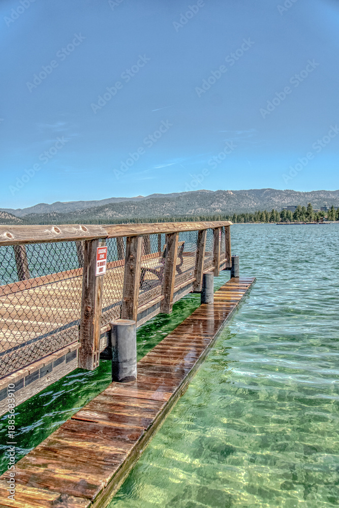 Fototapeta premium A wooden pier with a red sign on it