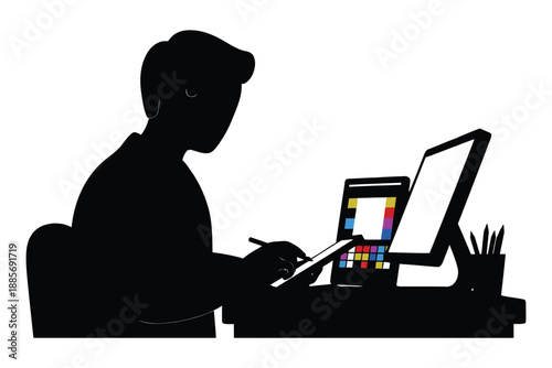 Man working on computer with graphics tablet and colorful palette on screen in office