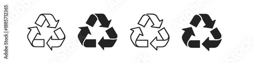 Collection of four recycling symbols in black and white outline and solid fill variations
