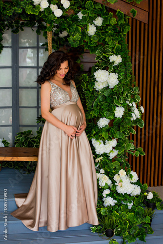 Pregnant woman at gold dress	
