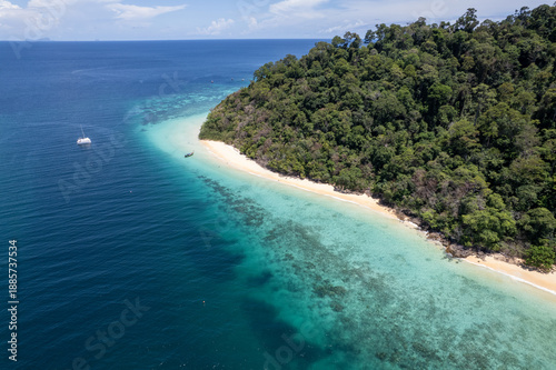 Tropical paradise white sand beach with palm trees on Koh Rok, Mu Ko Lanta National Park.