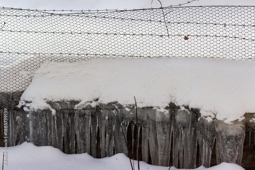 custom made wallpaper toronto digitalSecurity fence with sharp barbed wire and hexagonal mesh, heavily laden with fresh, thick snow and majestic, elongated icicles. Winter's grip