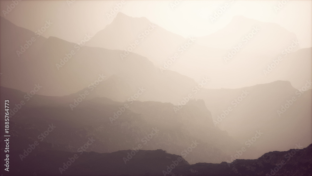 Naklejka premium A serene landscape of layered mountains emerges under soft evening light, with mist swirling around the peaks, creating a tranquil mood in natures embrace.