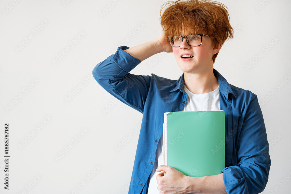 Obraz premium Student boy with messy red hair very surprised and excited