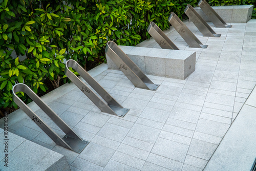 Modern bicycle parking garage made of stainless steel with bicycle symbol.