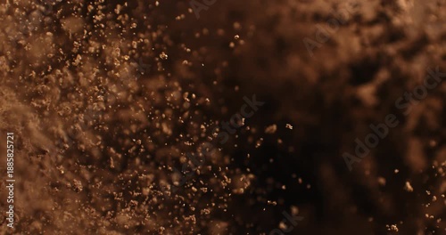 Slow Motion Coffee Powder Cloud Rising On Black Background. Ground Coffee Dust Explosion, Aromatic Texture And Cinematic Particles