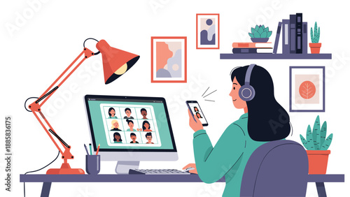 Freelance professional woman working from home while participating in a video conference call with several colleagues on her computer monitor.