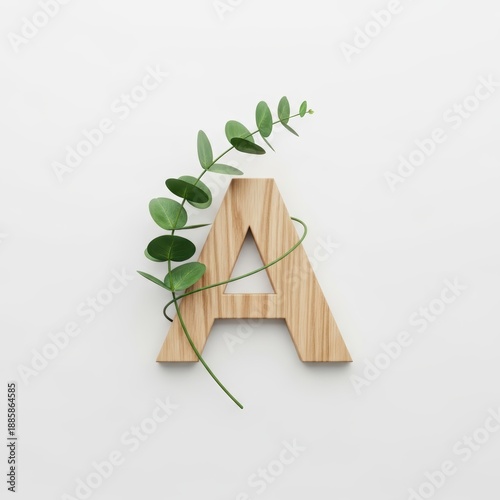 Wooden letter 'A' decorated with greenery on a white background  