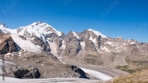 Stunning panoramic view of snow-capped peaks in Bernina range and the melting Pers Glacier in Swiss Alps