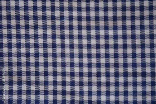 Blue and white gingham fabric texture background. Realistic checkered cotton material pattern, professional textile surface for fashion, kitchen, and picnic design mockup.