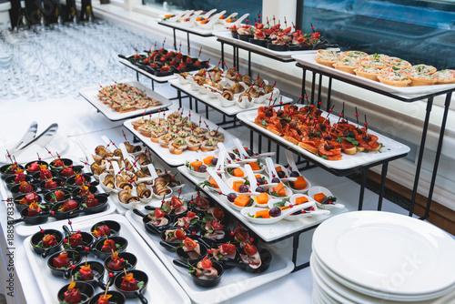 Fotografie Decorated catering table buffet, banquet with variety of different gourmet exqui