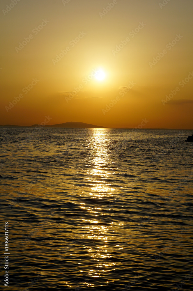 Fototapeta premium Summer sunset over the Adriatic Sea in shiny yellow colors