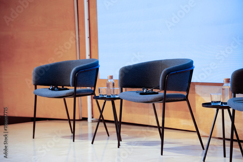 Conference stage chairs ready for panel discussion event