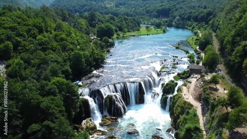 Aerial view of massive river cascades and railway trak in green canyon