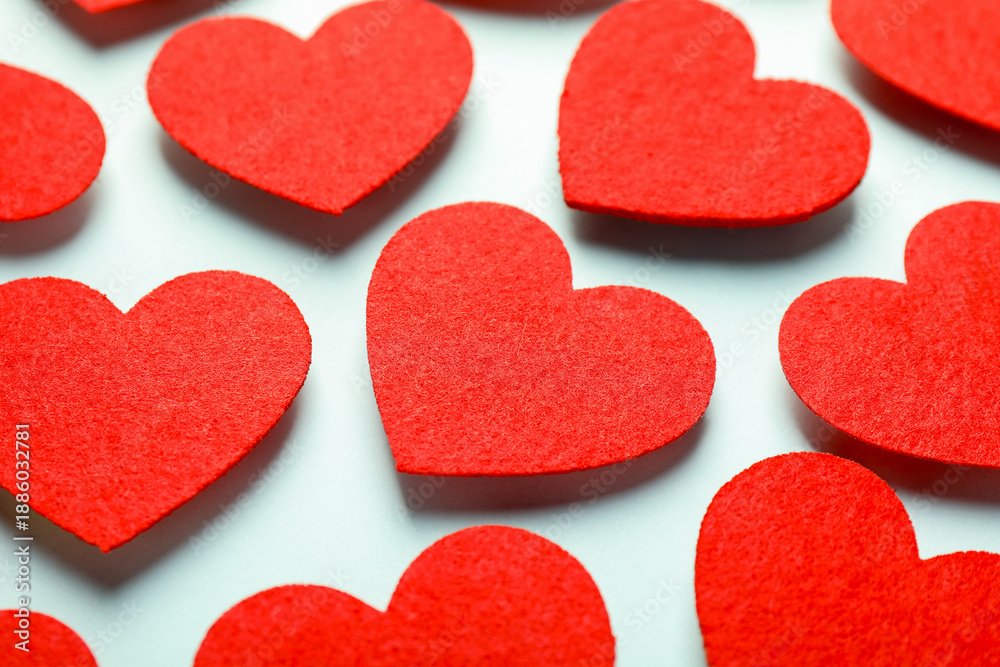 Obraz premium Love. Red decorative hearts on light blue background, closeup
