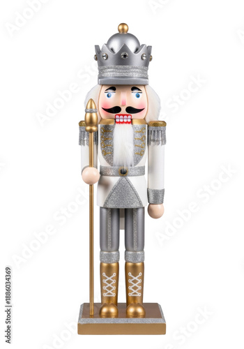 ornate wooden nutcracker soldier in a white and silver glitter uniform and jeweled crown, standing on a golden base, isolated against a transparent background. classic christmas holiday concept