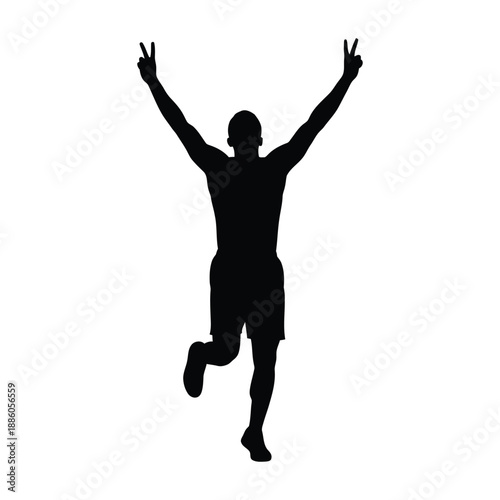 Silhouette of a person jumping with arms raised in victory