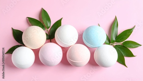 Four Pastel Spa Bath Bombs with Green Leaves on an Isolated Pink Background