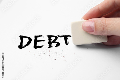 Canvas Print Woman erasing word Debt on white background, closeup