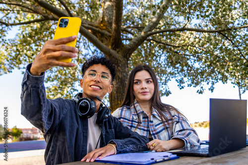 Bilde på lerret University students taking selfie while studying outdoors