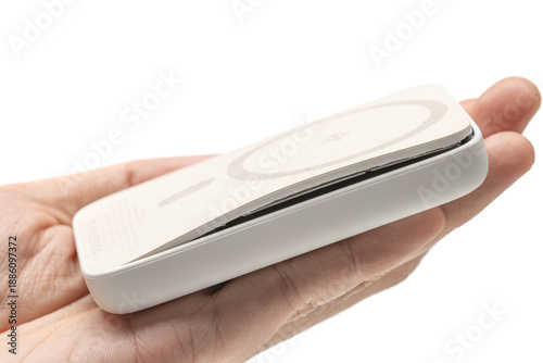 hand holding swollen powerbank or battery pack. isolated on white background.