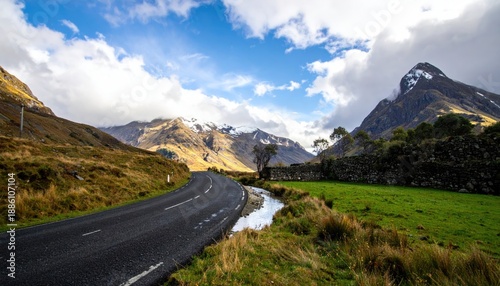 Winding Road Through Mountains with Cloudy Sky