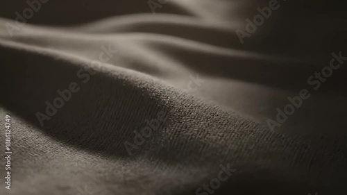 Macro Close-up of Soft Plush Fabric Textile Surface Draped in Warm Brown Tones, Creating Wavy Folds and Textured Abstract Background