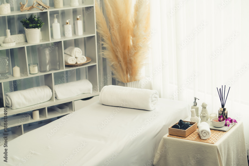 Fototapeta premium Exquisite display of beauty treatment and spa salon accessories arranged on spa table in luxury spa resort. Relaxing spa massage and recreation background concept. Quiescent