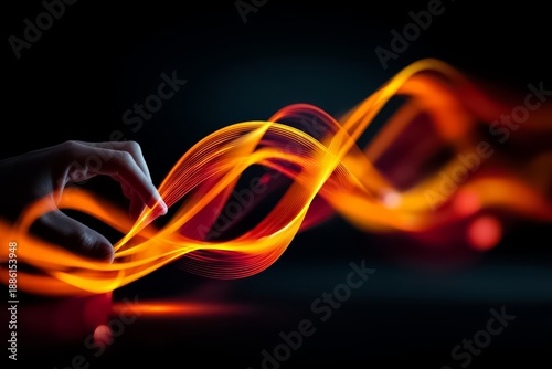 Hand is touching a wave of orange and red. Concept of energy and movement, as if the wave is alive and pulsating