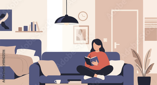 Young woman relaxing at home, engrossed in a book, enjoying quiet leisure time.
