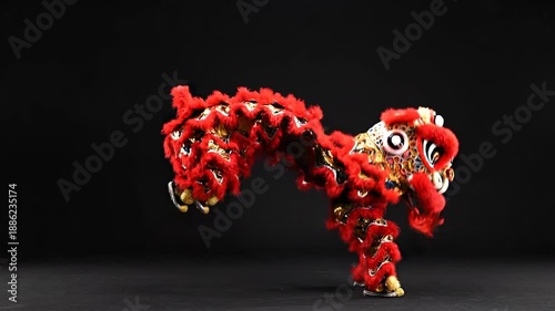 Vibrant red lion dance costume on display against black background