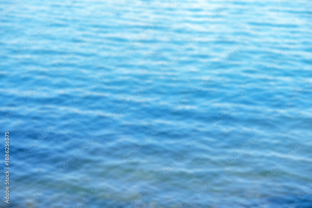 Fototapeta premium Calm blue sea water. Blurred background. Space for text.