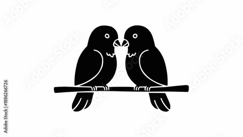 Two black lovebirds perched on a branch silhouette.